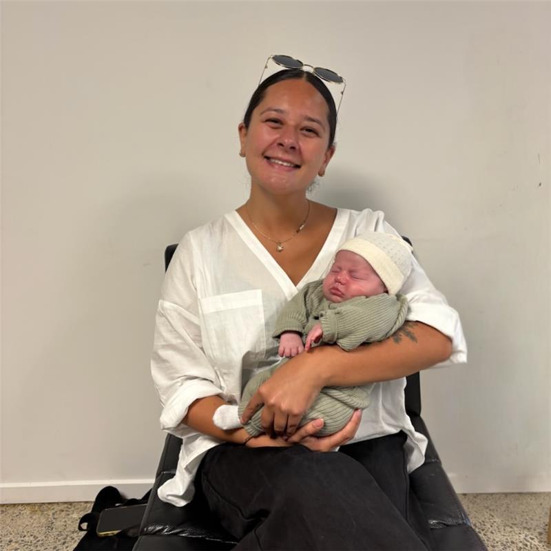 Ana, midwife at Hana Midwifery, holding a newborn baby
