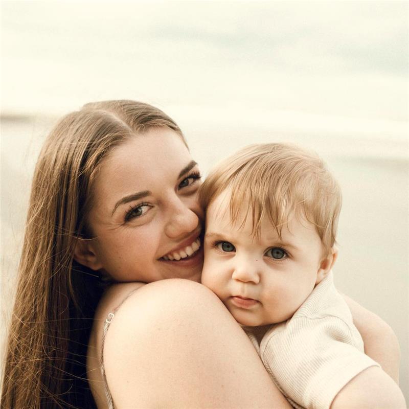 Harriet, midwife at Hana Midwifery, holding a baby